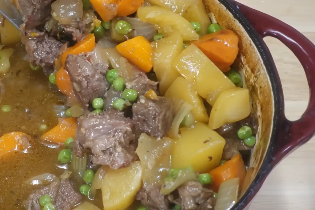 finished beef stew with potatoes, carrots, onions in dutch oven