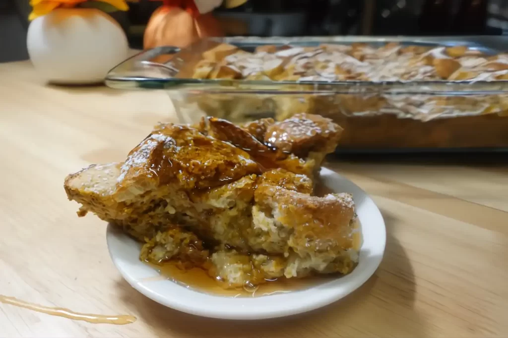 pumpkin french toast casserole on serving plate with syrup