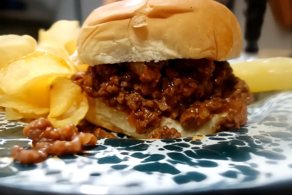 sloppy-joe-on-plate-with-chips-and-pickles