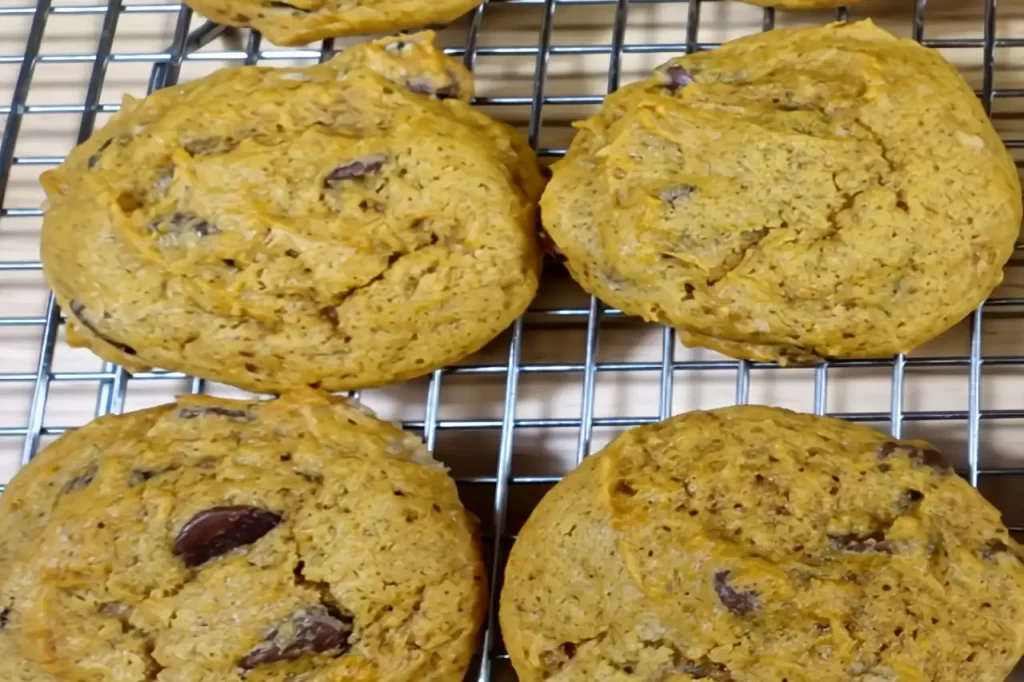 upclose shot of pumpkin chocolate chip cookies on cooling rack