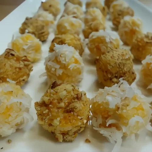 apricot-coconut-balls-on-white-platter-close-up