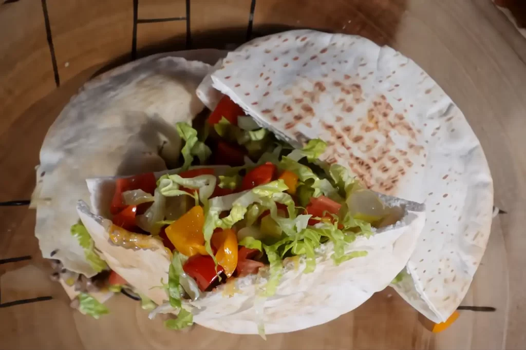 cheese-burger-pitas-on-a-wooden-board-with-lettuce-and-tomato