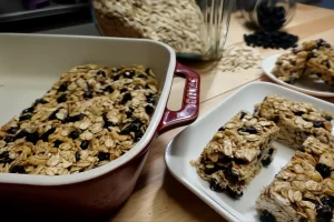 chewy-granola-bars-on-white-serving-plate-and-in-red-staub-dish