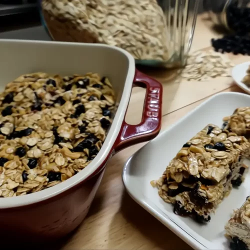 chewy-granola-bars-on-white-serving-plate-and-in-red-staub-dish