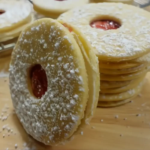 raspberry-cream-sandwich-cookies dusted with powdered sugar