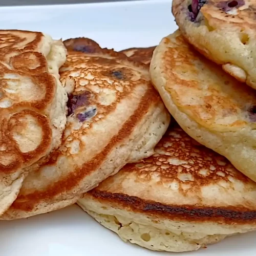 blueberry-pancakes-on-white-platter.
