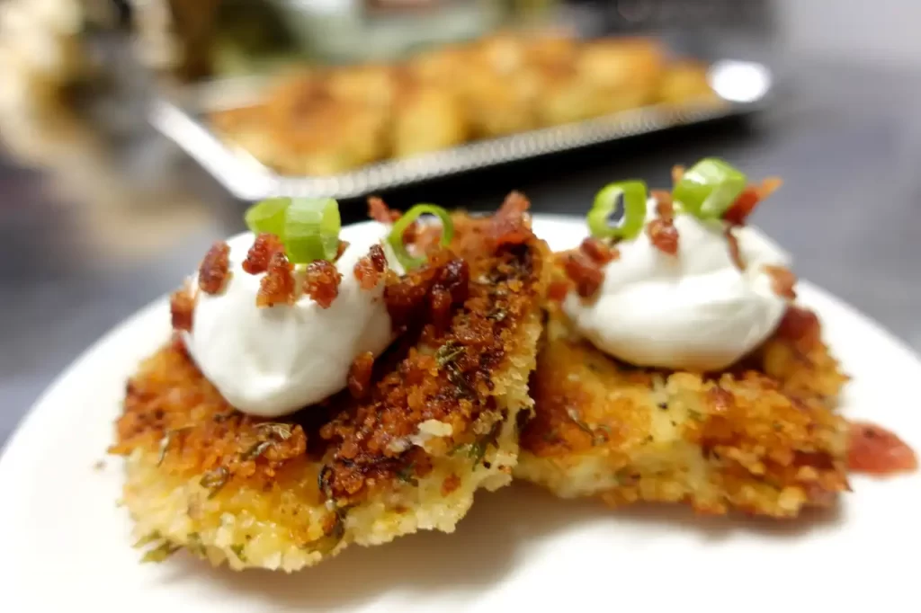 close-up-loaded-mashed-potato-cakes-with-sour-cream