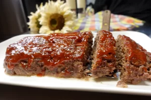 close-up-of-moist-meatloaf-recipe-on-white-platter-sliced