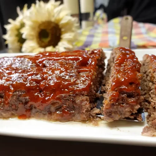 close-up-of-moist-meatloaf-recipe-on-white-platter-sliced