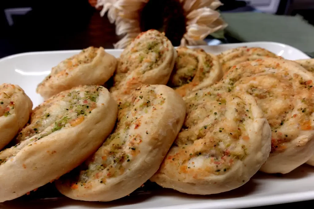 side-view-broccoli-ham-rolls-on-white-platter.
