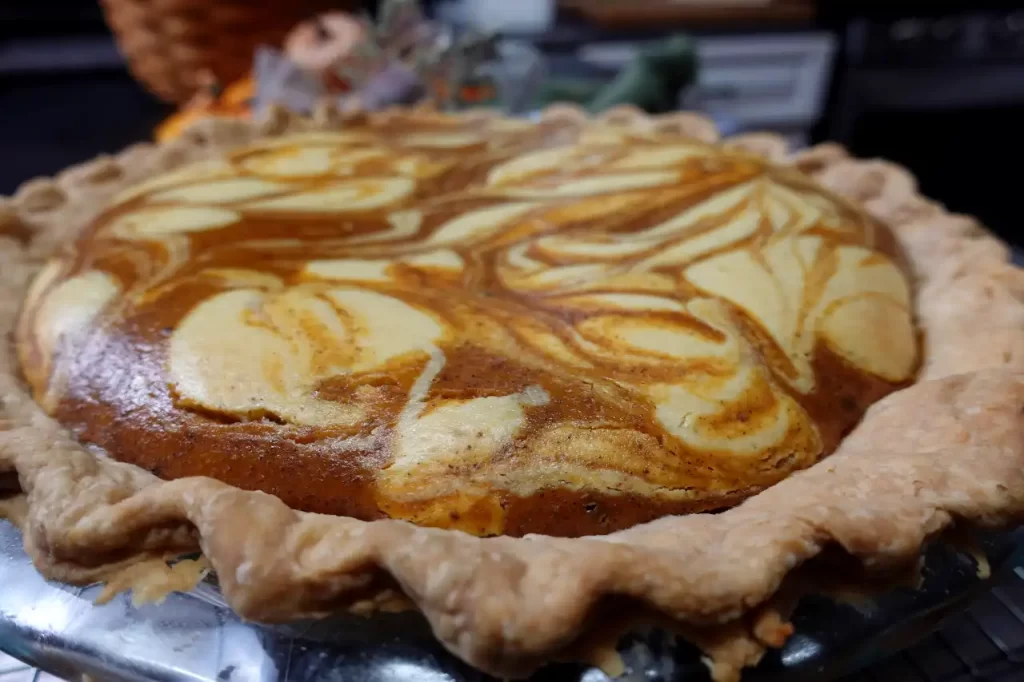 side view pumpkin pie with cream cheese swirl