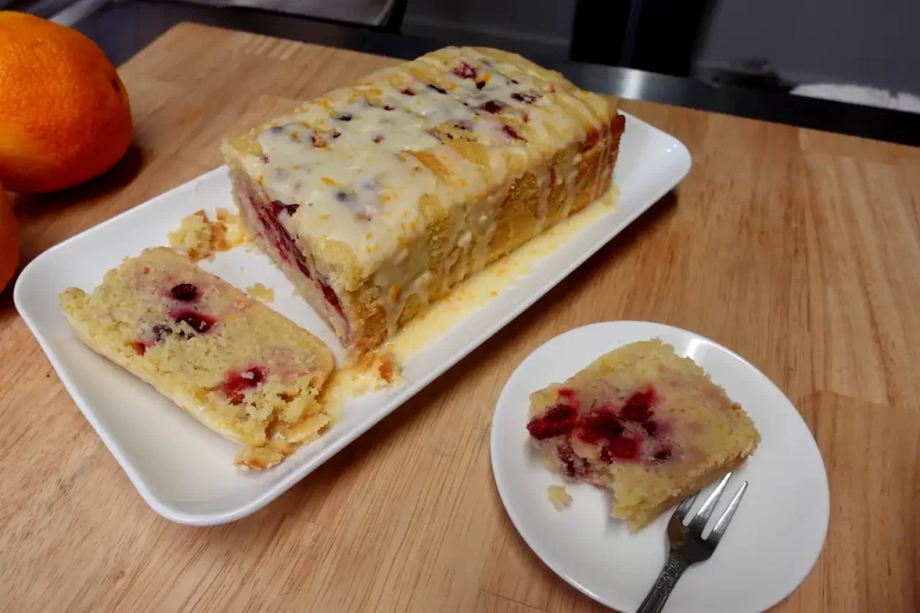 cranberry-orange-bread-serving-on-plate-with-a-fork.