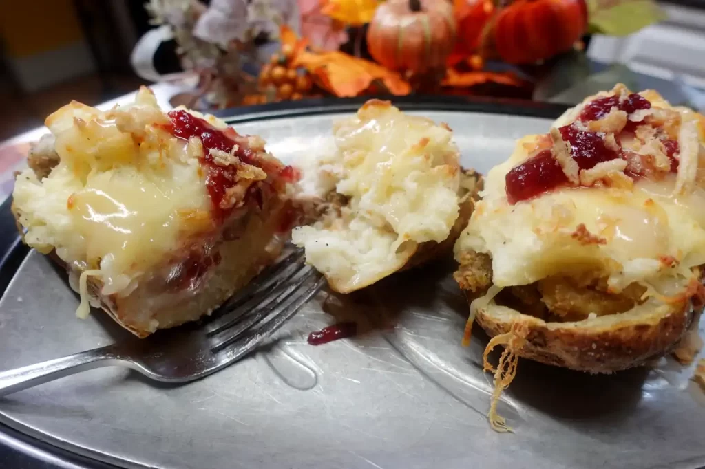 loaded-potato-cut-in-half-on-serving-plate-showing-all-the-thanksgiving-fillings