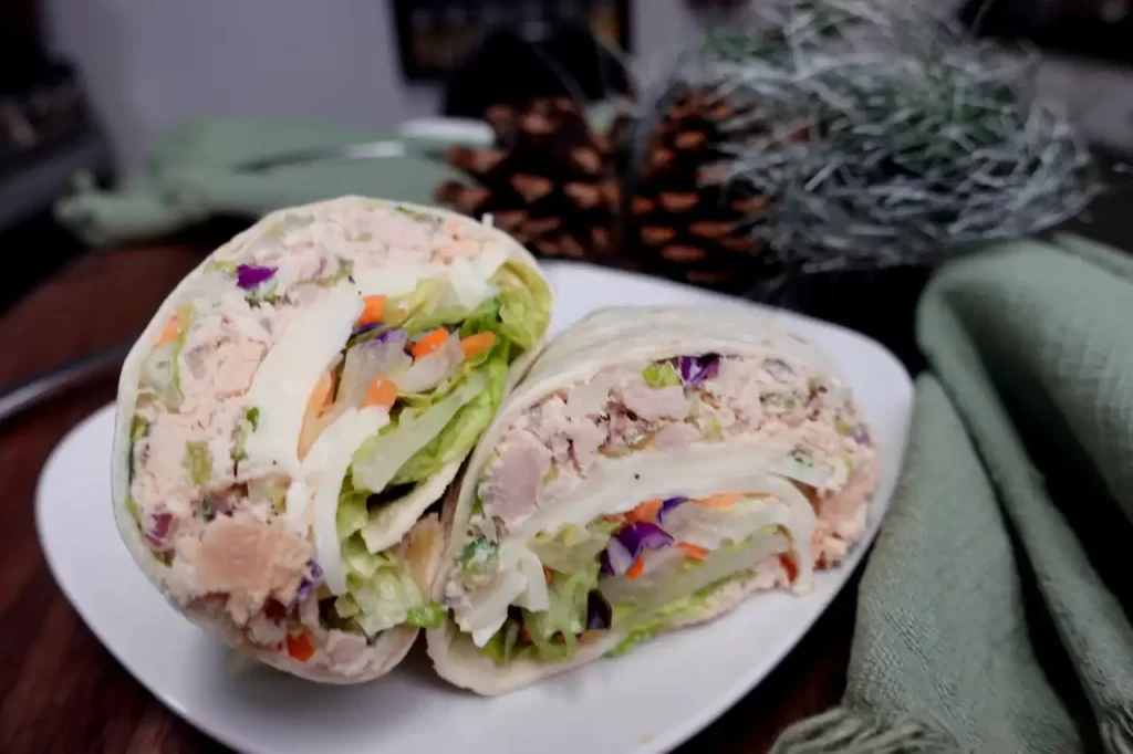 close-up-tuna-salad-wrap-on-white-plate