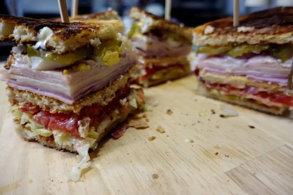 club-sandwiches-cut-into-wedges-on-cutting-board.