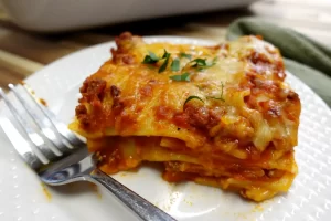 classic-beef-lasagna-serving-on-white-plate.