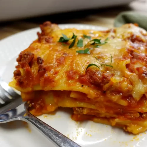 classic-beef-lasagna-serving-on-white-plate.