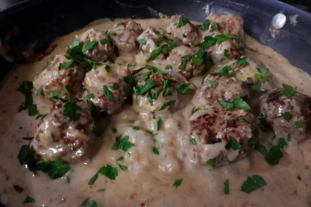 top-view-meatballs-in-creamy-leek-sauce-in-skillet