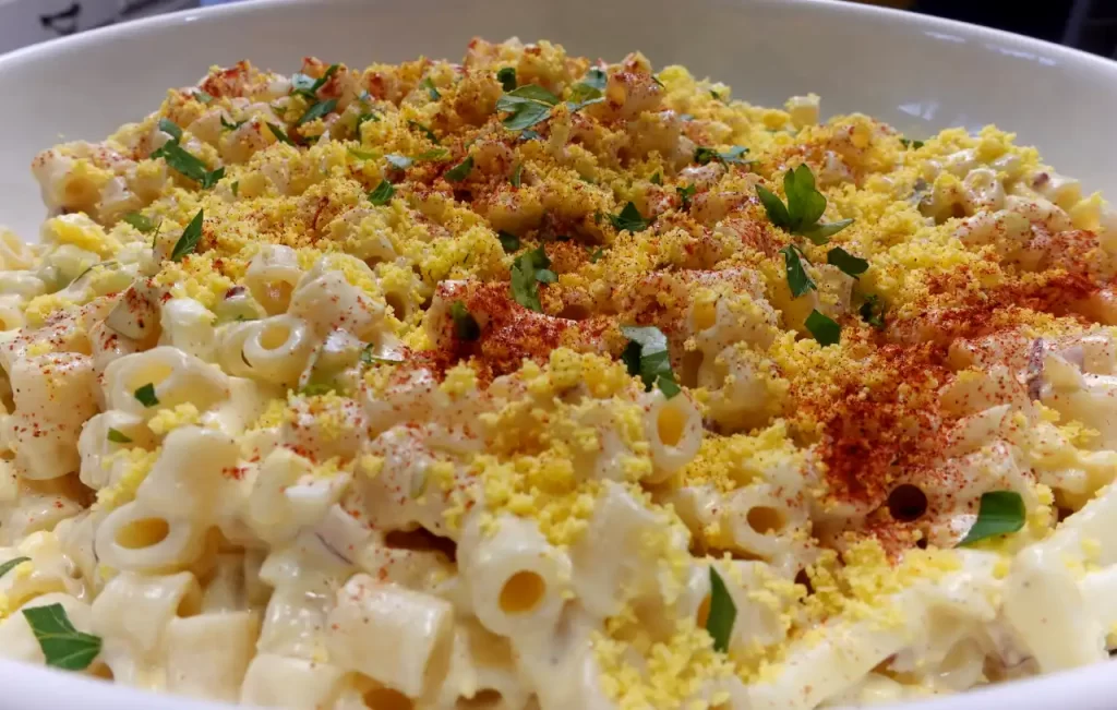 close-up-deviled-egg-pasta-salad-in-white-serving-bowl.