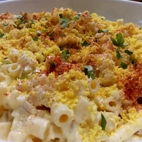 close-up-deviled-egg-pasta-salad-in-white-serving-bowl.