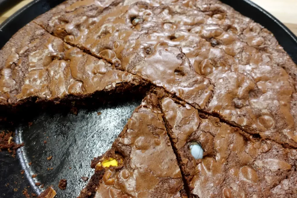 pan-of-cadbury-egg-brownies-in-cast-iron-skillet-with-slice-removed
