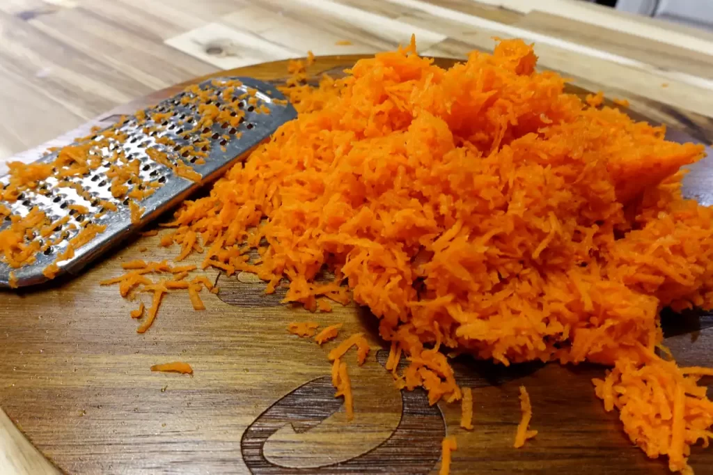 carrots-finely-grated-on-wooden-cutting-board
