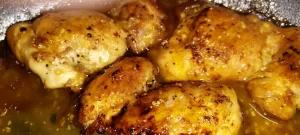close-up-orange-butter-chicken-in-cast-iron-skillet