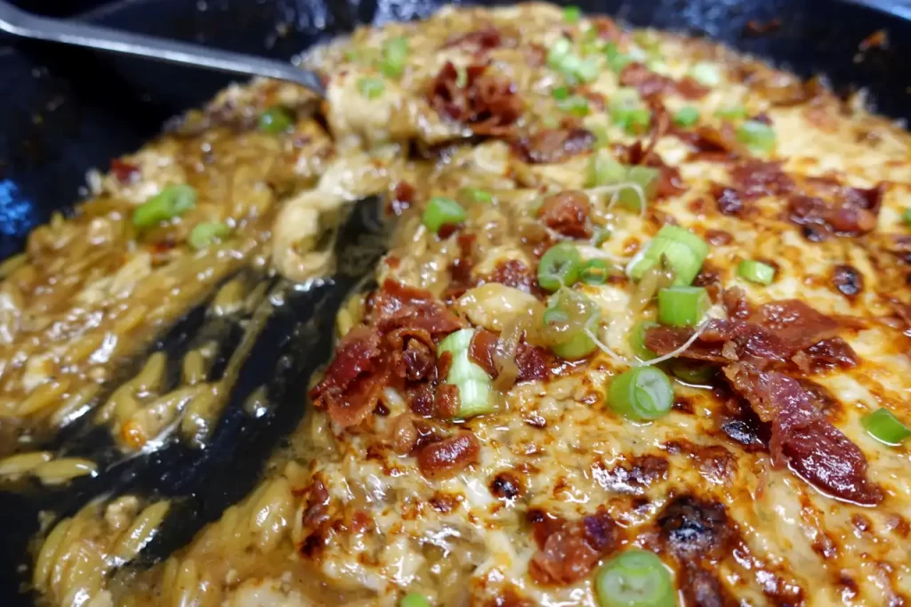 french-onion-cheesy-orzo-in-skillet-being-served