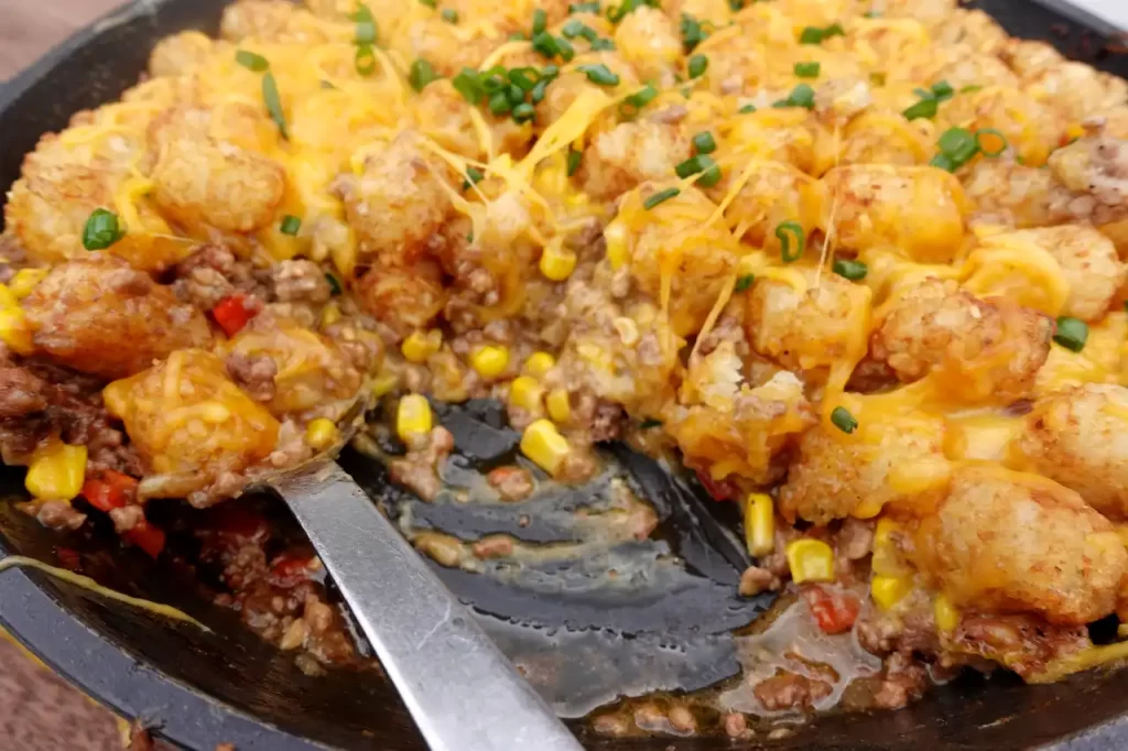 close-up-cowboy-tater-tot-skillet-with-serving-scooped-out