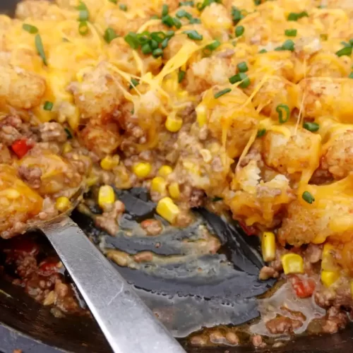 close-up-cowboy-tater-tot-skillet-with-serving-scooped-out
