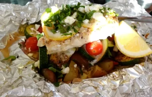 close-up-haddock-on-foil-with-feta-sprinkled-on-top