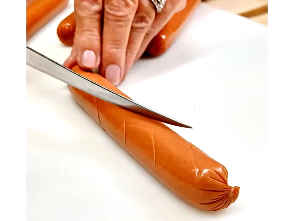 image-of-scoring-hot-dogs-in-criss-cross-pattern.webp
