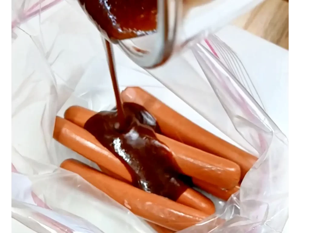 marinate-being-poured-over-hot-dogs-in-zip-loc-bag.webp