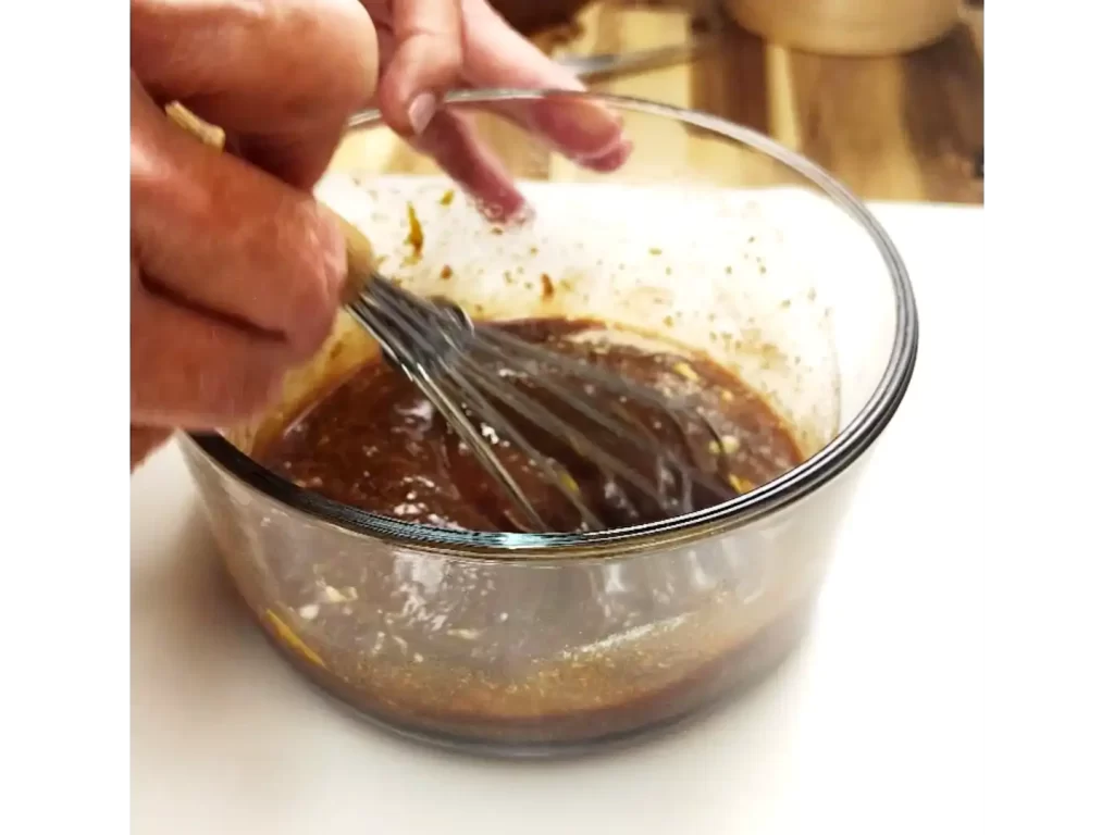 mixing-marinade-in-a-bowl-with-whisk.webp