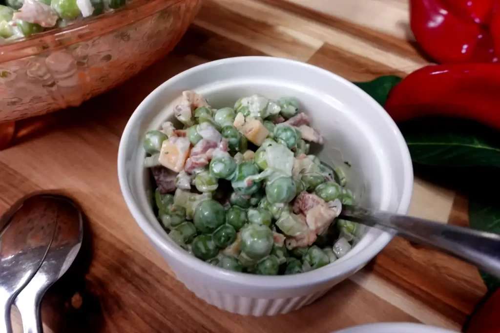 serving-of-bacon-pea-salad-in-white-serving-dish