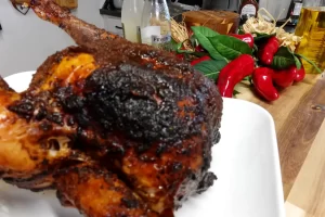 smoked-sweet-onion-ginger-beer-chicken-on-platter-on-wooden-table
