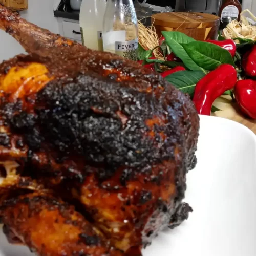 smoked-sweet-onion-ginger-beer-chicken-on-platter-on-wooden-table
