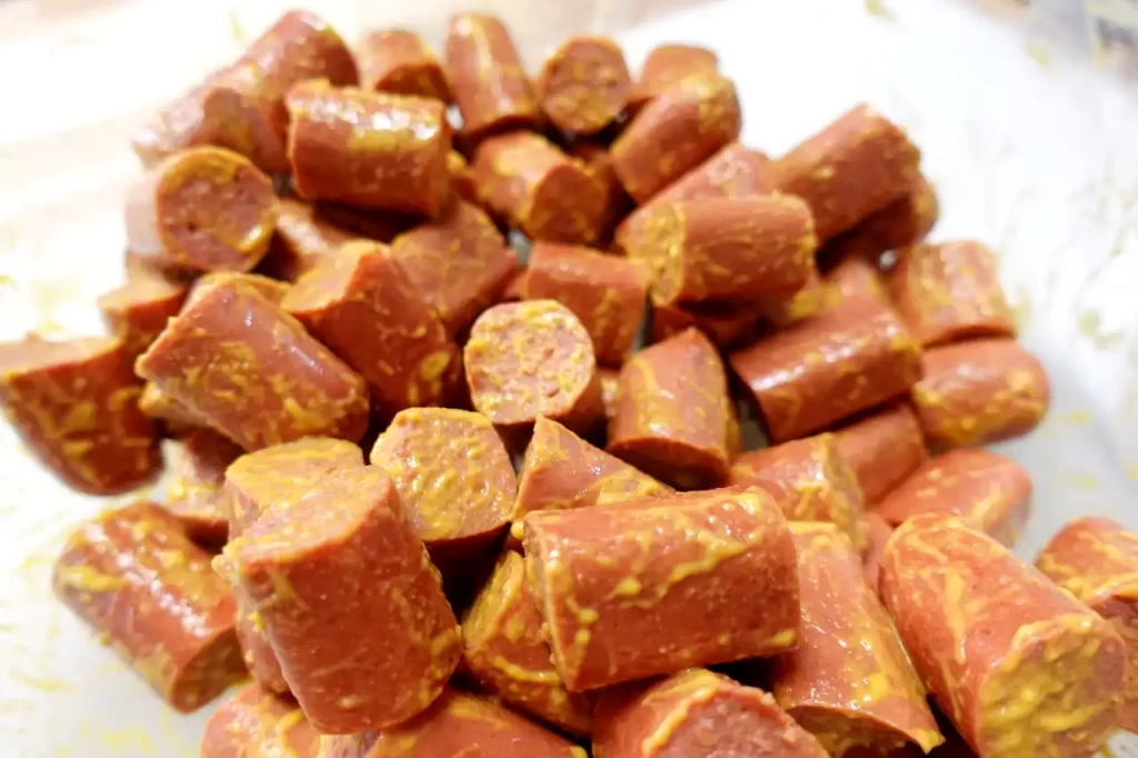 all-beef-hotdogs-cut-into-bite-sized-pieces-and-coated-in-yellow-mustard