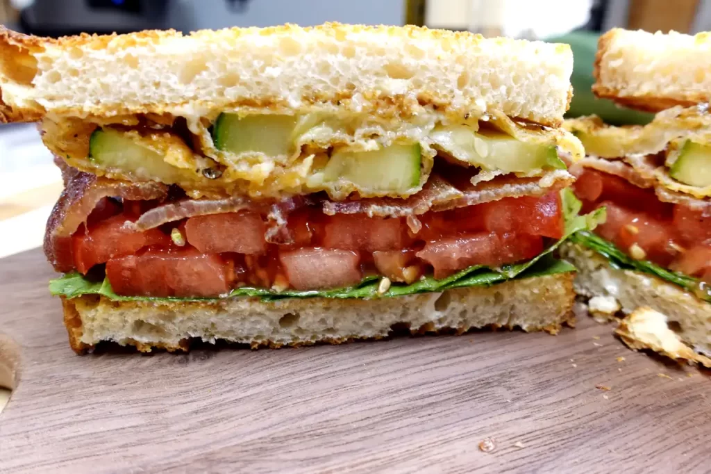 front-view-Crispy-Fried-Zucchini-BLT-made-with-Parmesan-crusted-zucchini-bacon-tomatoes-lettuce-mayonnaise-and-toasted-sourdough-bread.webp