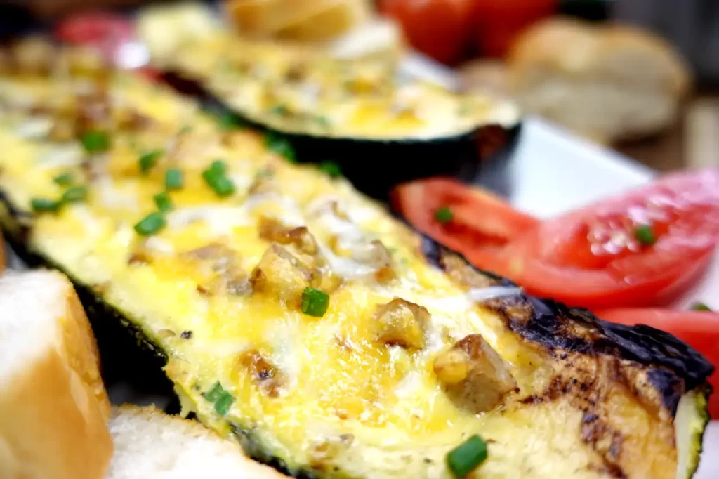 Breakfast-stuffed-zucchini-boats-with-sausage-eggs-and-melted-cheddar-cheese-topped-with-fresh-green-onions