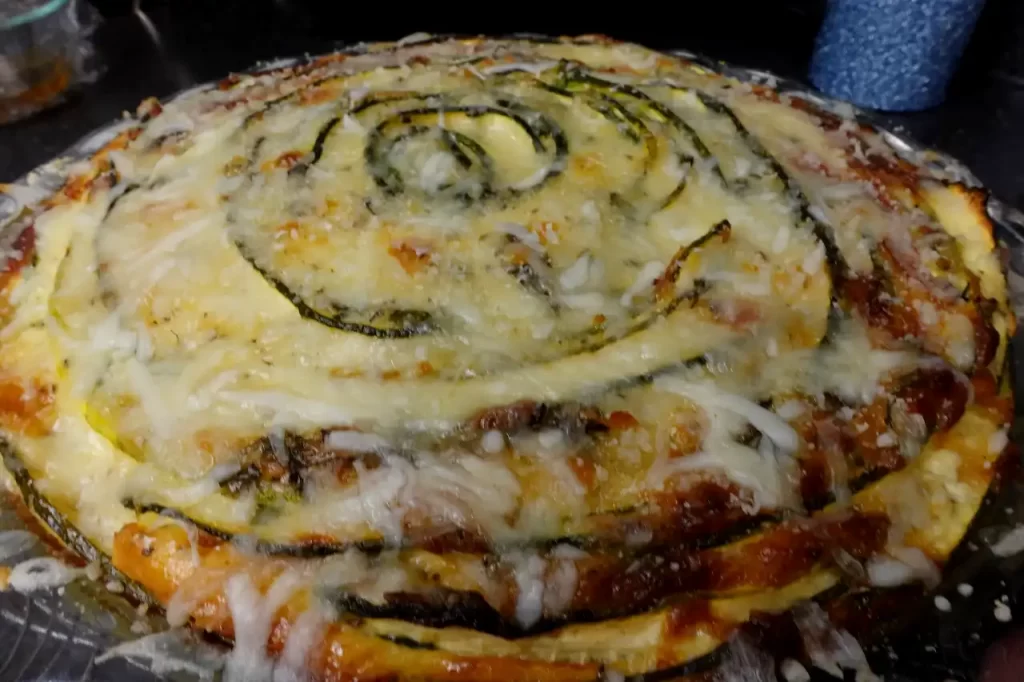 Overhead-view-of-crustless-zucchini-rose-pie-arranged-in-a-spiral-rose-pattern.