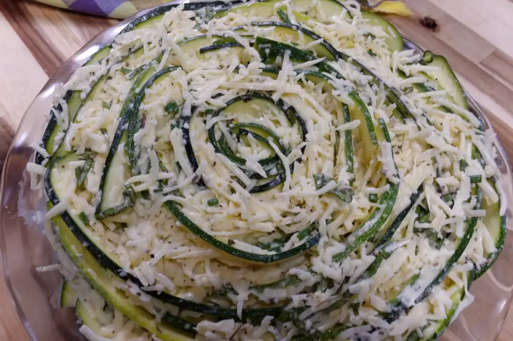 crustless-zucchini-rose-pie-ready-for-oven-with-mozzarella-cheese-sprinkled-on-top.