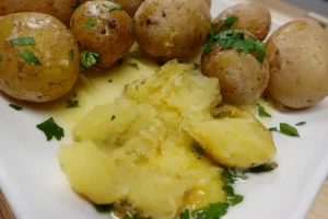 salt-potatoes-on-plater-one-cut-open-showing-creamy-butter-inside