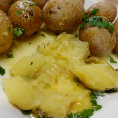 salt-potatoes-on-plater-one-cut-open-showing-creamy-butter-inside