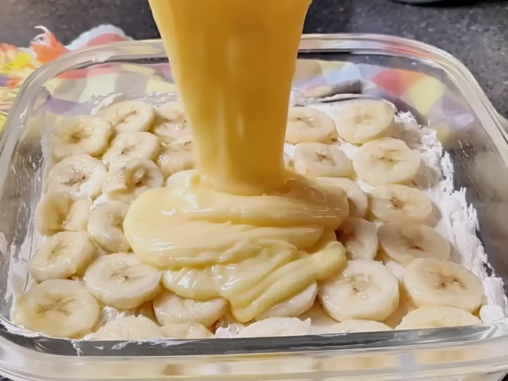 vanilla-pudding-being-poured-on-bananas.