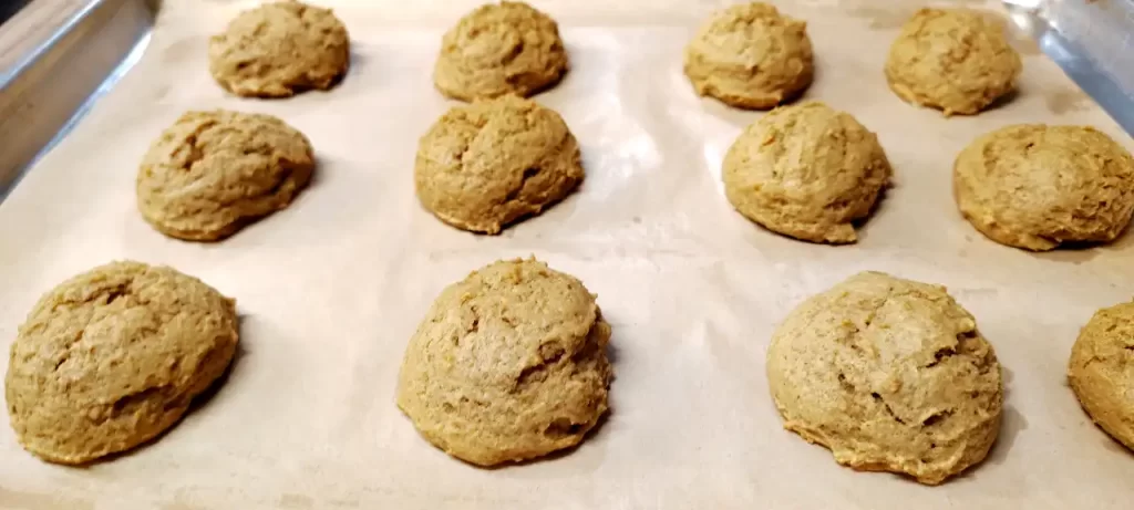 Scoops-of-pumpkin-cookie-dough-on-a-parchment-lined-baking-sheet.