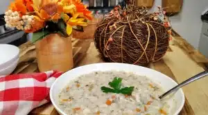 white-Bowl-of-creamy-chicken-and-wild-rice-soup-with-shredded-chicken-carrots-celery-and-parsley.